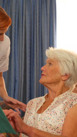 Female-doctor-talking-to-senior-people