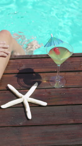 Woman-sitting-near-swimming-pool