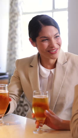 Laughing-businesswomen-having-a-glass-of-beer-after-work