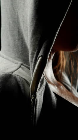 Muscular-woman-wearing-grey-hood