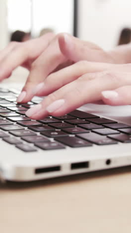 Close-up-view-of-a-woman-typing-on-her-laptop