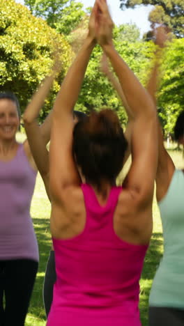 Fitness-class-doing-star-jumps-together