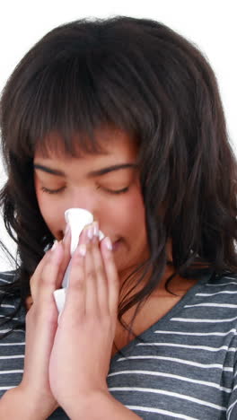 Woman-blowing-nose-with-tissue-paper-