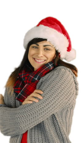 Woman-in-santa-hat-and-warm-clothing-blowing-over-hands-