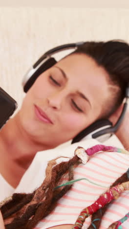 Smiling-lesbian-couple-listening-music-together