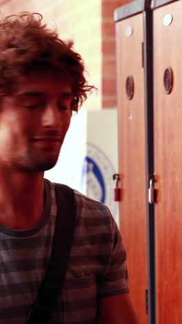 Student-walking-to-and-opening-his-locker