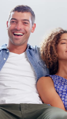 Cute-couple-watching-TV-and-reading