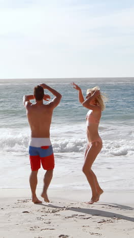 Happy-friends-jumping-at-the-beach