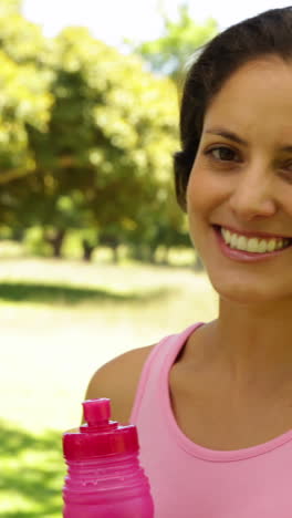 Happy-woman-wearing-pink-for-breast-cancer-awareness-drinking-water