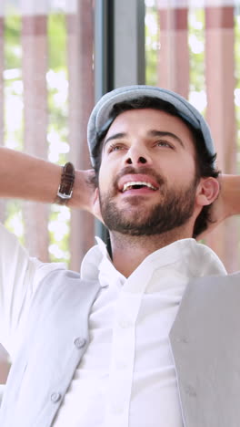 Happy-hipster-businessman-using-his-computer