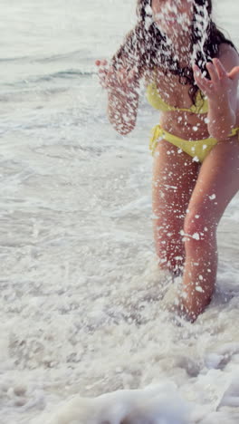 Smiling-young-woman-playing-with-waves