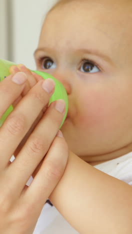 Pretty-young-mother-feeding-her-baby-girl