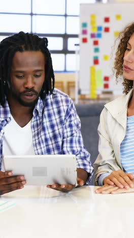 Colleagues-interacting-with-each-other-over-digital-tablet