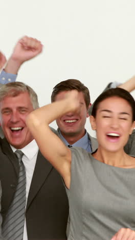 Business-people-cheering-in-front-of-camera-