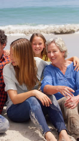 Multi-generation-family-sitting-on-the-beach