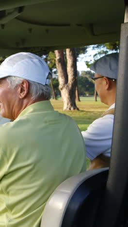 Two-golfers-driving-in-their-golf-buggy-