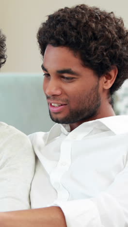 Homosexual-couple-speaking-and-reading-newspaper