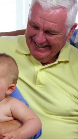 Happy-family-smiling-and-looking-the-baby