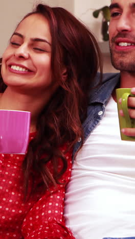 Happy-couple-drinking-hot-beverage-