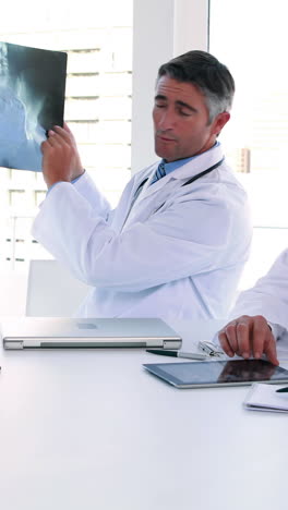 Medical-team-looking-at-x-ray-during-a-meeting