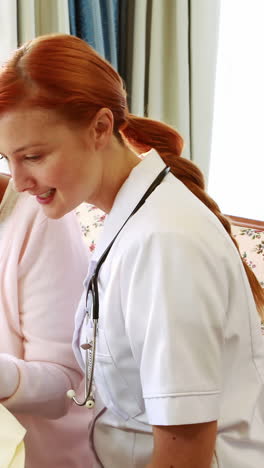 Nurse-and-old-woman-reading-book-together