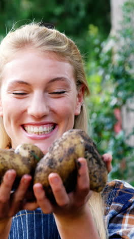 Happy-gardener-holding-freshly-cultivated-potatoes