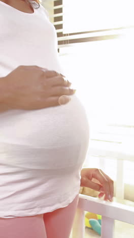 Pregnant-woman-looking-at-new-cot