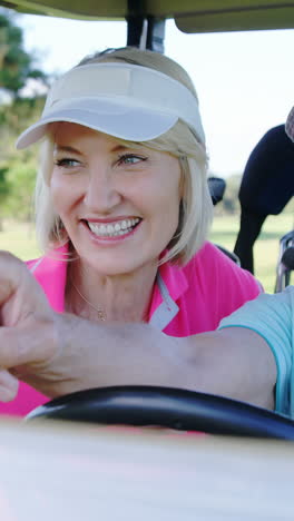 Two-golfers-driving-in-their-golf-buggy-