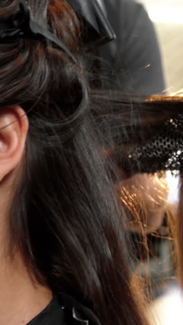 Woman-getting-her-hair-dried-with-hair-dryer