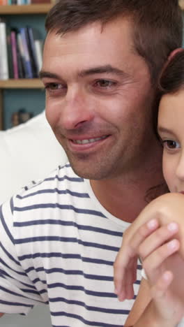 Father-and-daughter-using-computer-together