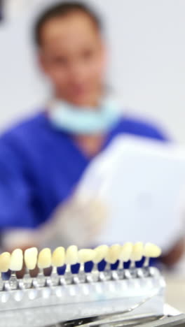 Dentist-examining-a-patients-teeth-in-the-dentists-chair