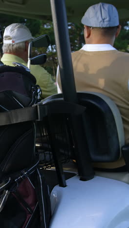 Two-golfers-driving-in-their-golf-buggy-