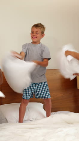 Parents-and-son-having-a-pillow-fight