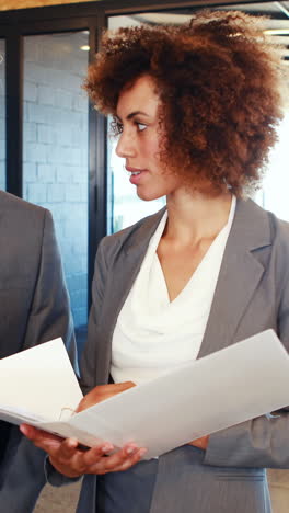 Business-team-standing-together-discussing-work