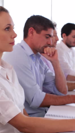 Stern-business-team-listening-to-a-presentation-