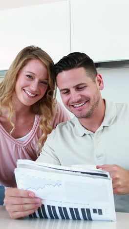 Happy-couple-smiling-at-the-camera-in-the-morning