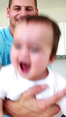 Father-playing-airplane-with-his-baby-boy