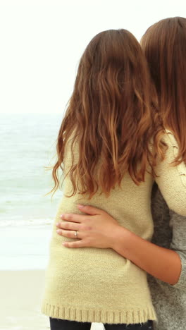 Mother-and-daughter-looking-at-beach