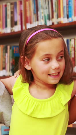 Pupils-smiling-at-camera-in-library