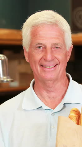 Senior-man-with-baguettes-in-supermarket