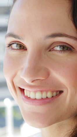 Natural-young-businesswoman-smiling-at-camera-