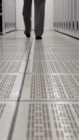 Data-technician-walking-through-locker-hall