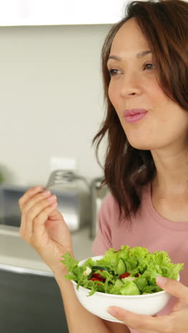 Pretty-woman-eating-a-bowl-of-healthy-salad