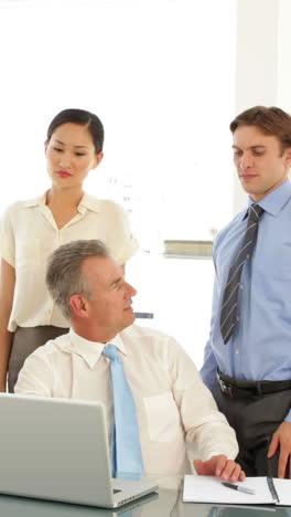 Hard-working-business-team-talking-in-front-of-laptop