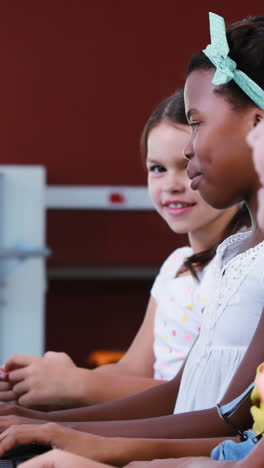 Schoolgirls-using-computer-in-classroom