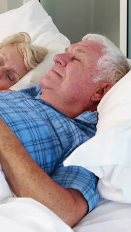 Senior-couple-sleeping-in-bed