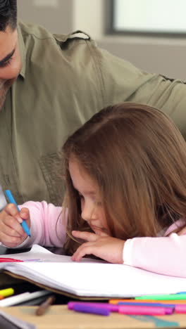 Little-girl-drawing-at-the-table-with-her-father