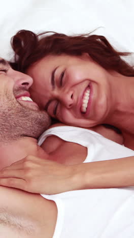 Happy-couple-laughing-in-bed