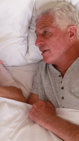 Senior-couple-lying-in-bed