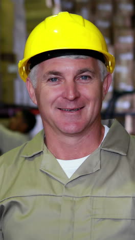 Warehouse-worker-smiling-at-camera-